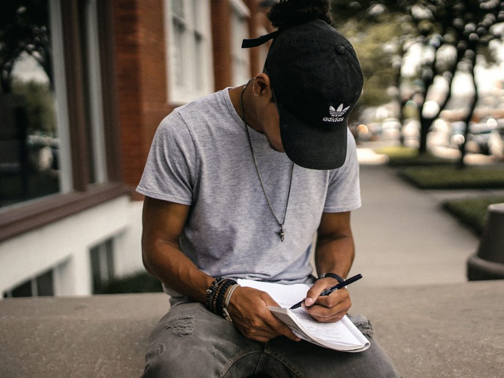 A man taking notes of his habits - habit tracking