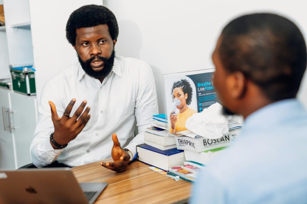 A man consulting with a health professional about health insurance plan