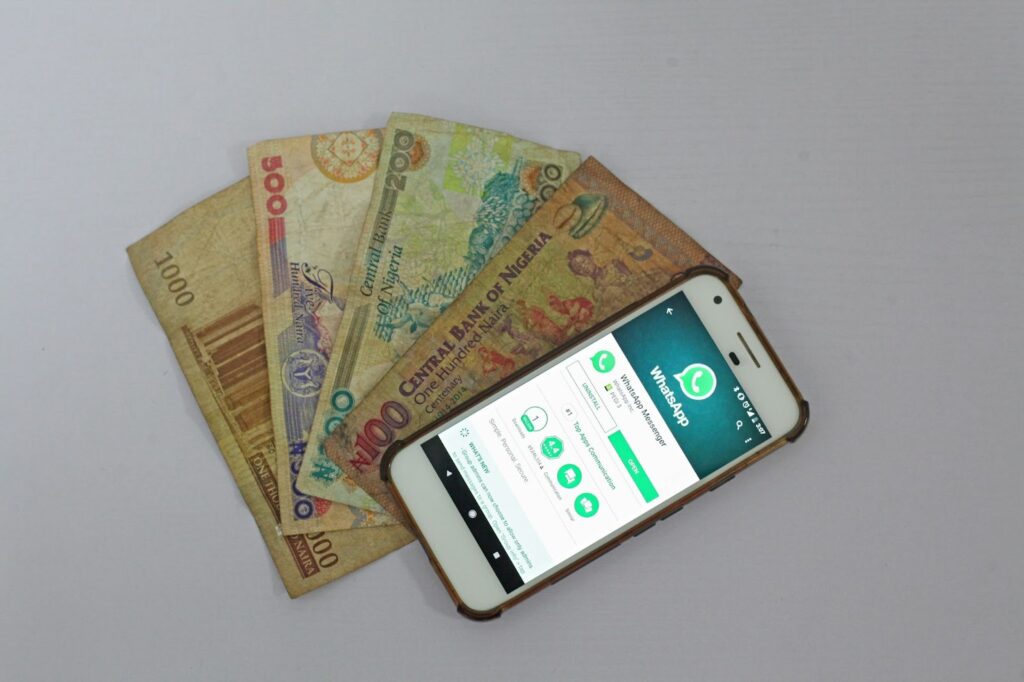 A phone device with naira notes - online loan apps in Nigeria