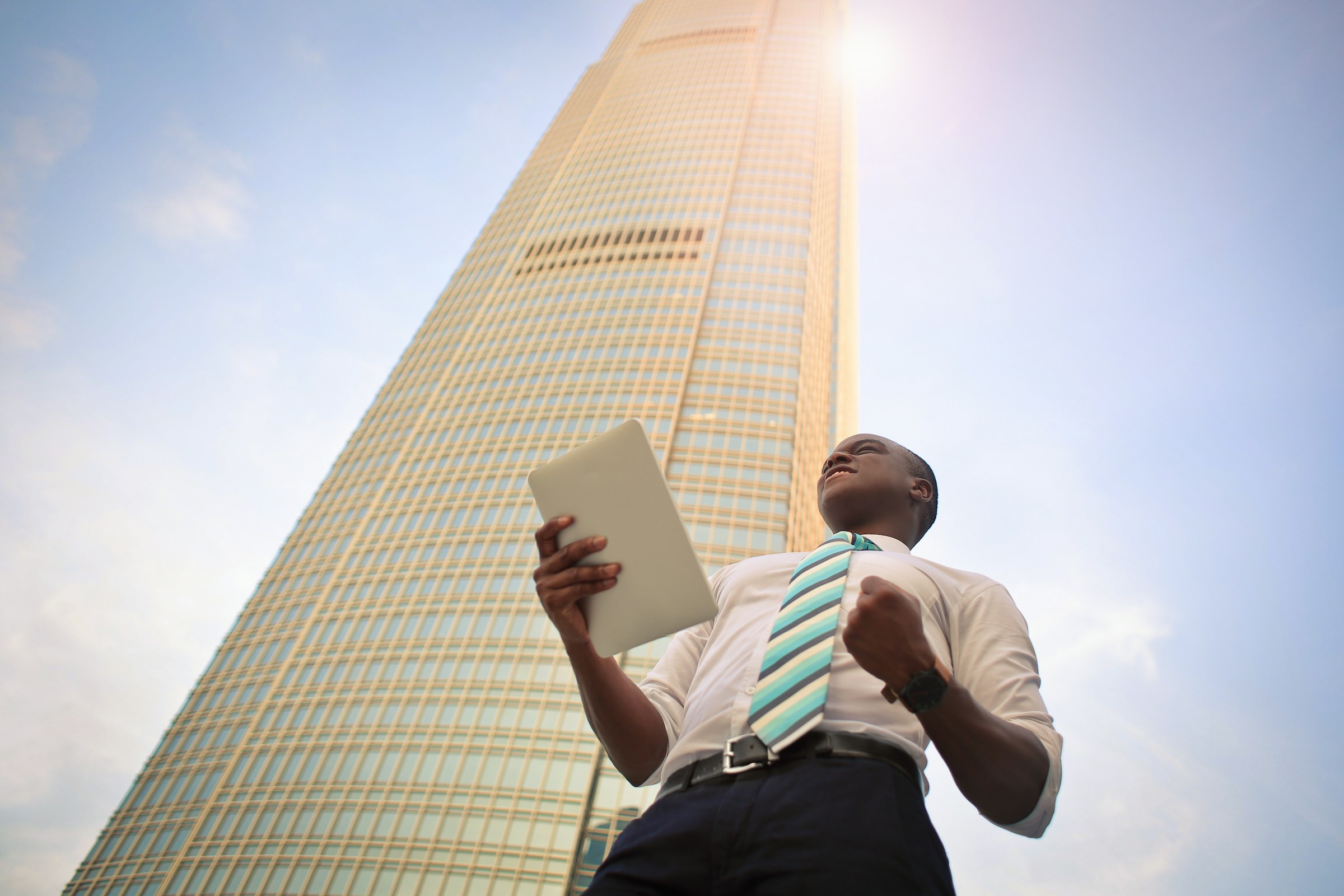 A man in front of a building - Money Saving Advice Every Entrepreneur Needs To Build Wealth