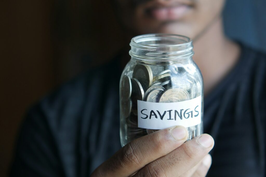 A man holing a saving jar - money saving advice
