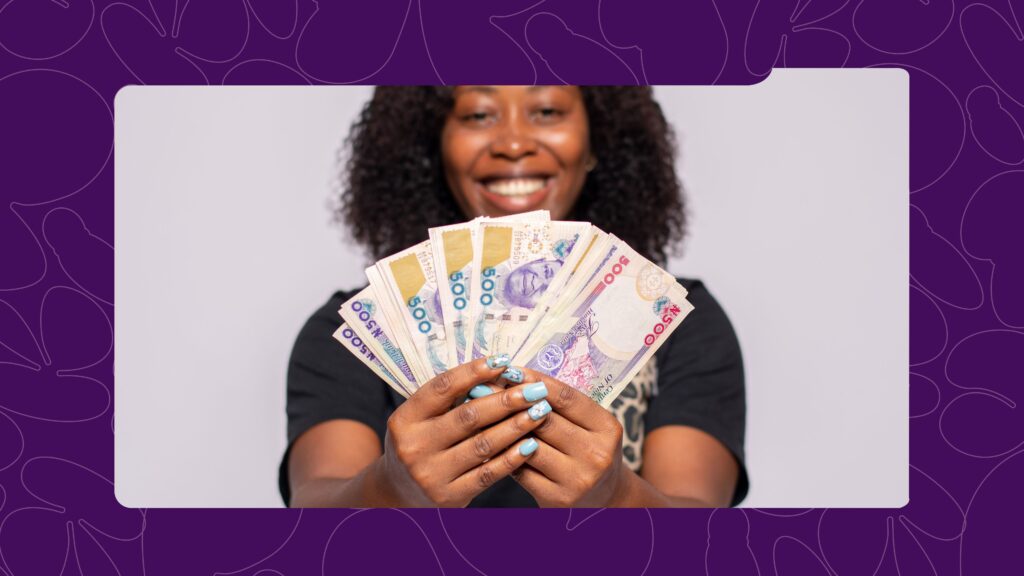 A woman holding Nigerian naira notes - how to save money fast in Nigeria