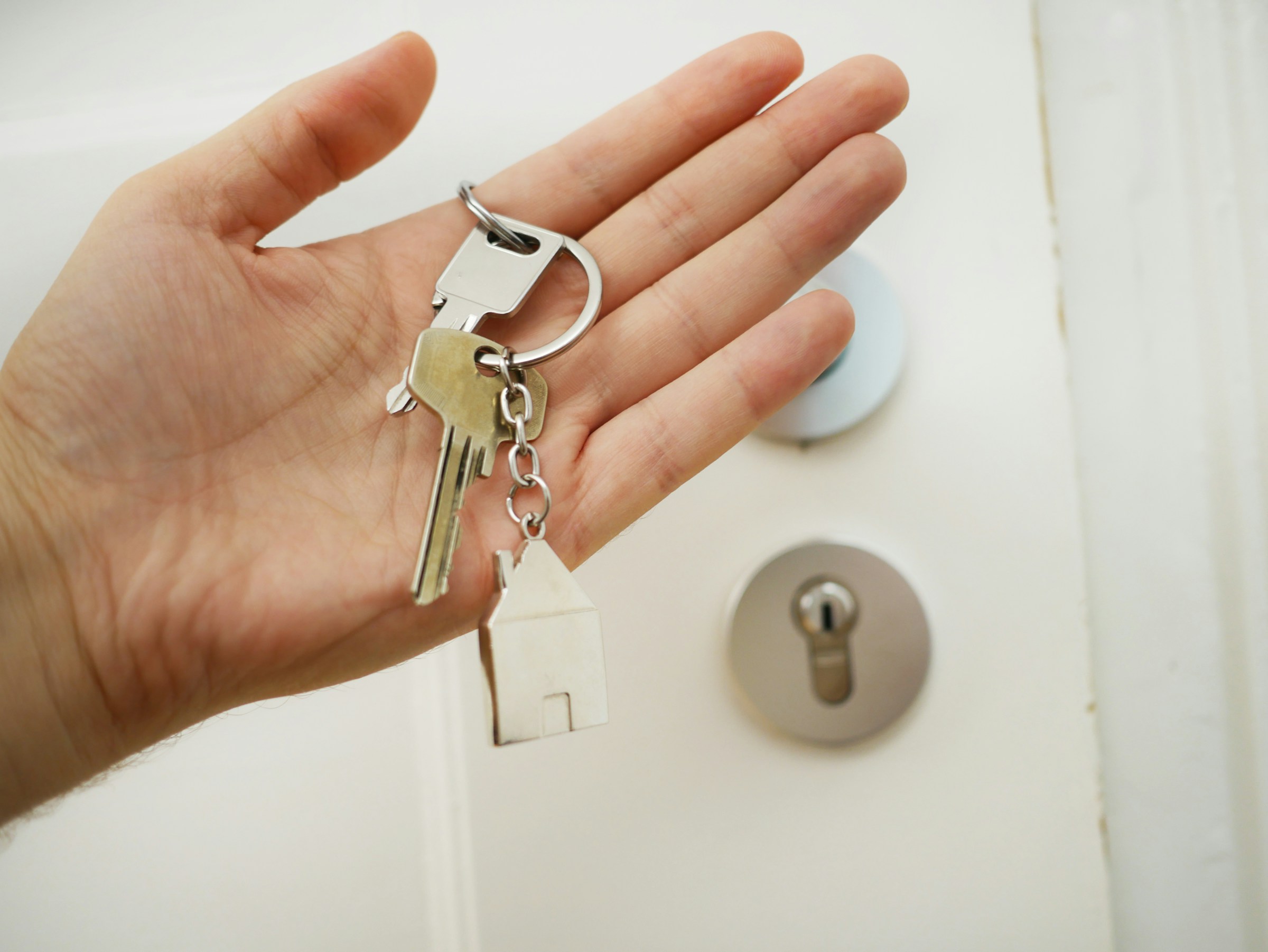 A man holding a house key -Mortgage banks in Nigeria