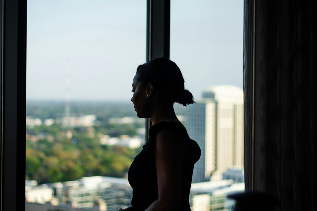 A woman staring through the glass wall - challenges of doing business
