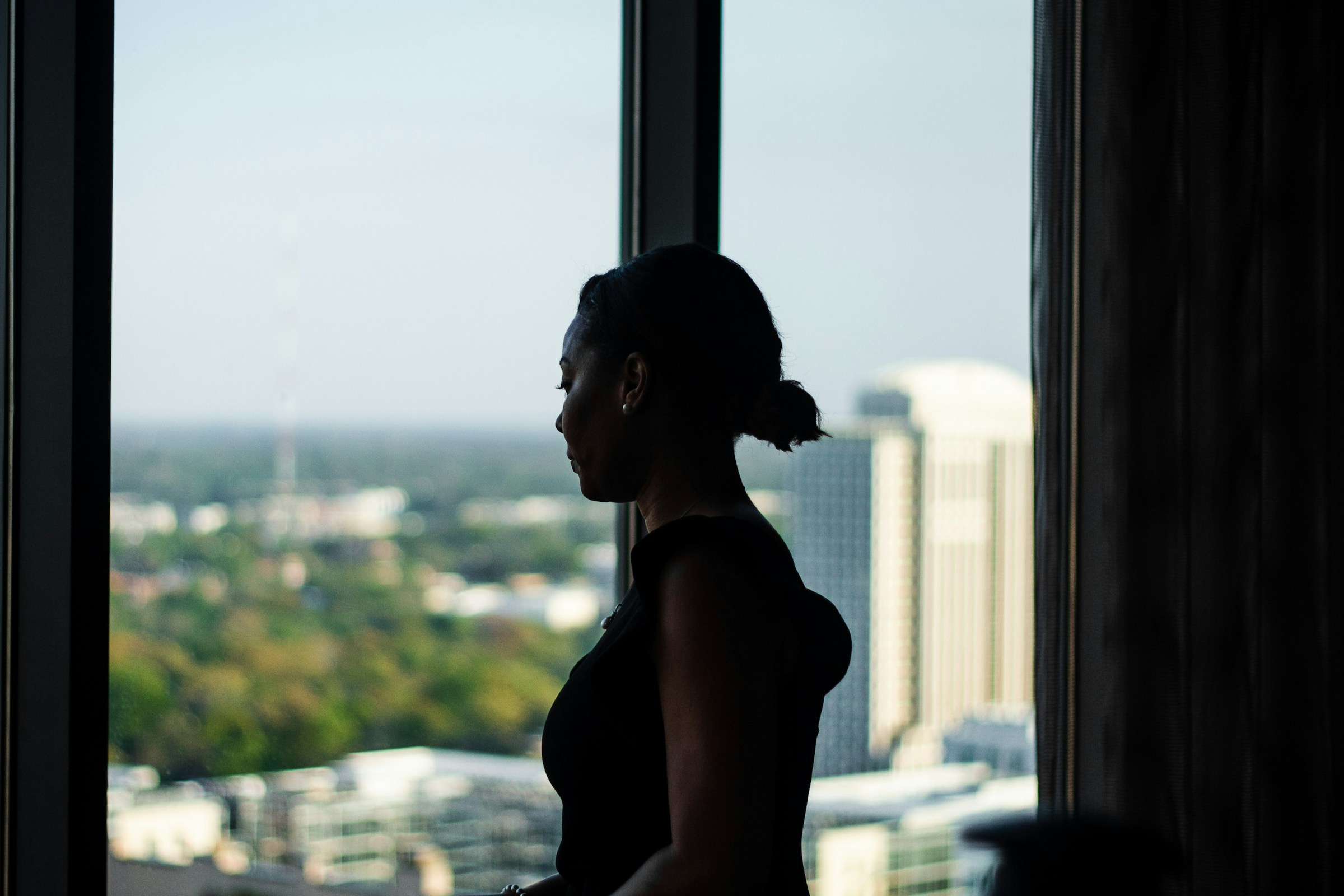 A woman staring through the glass wall - challenges of doing business
